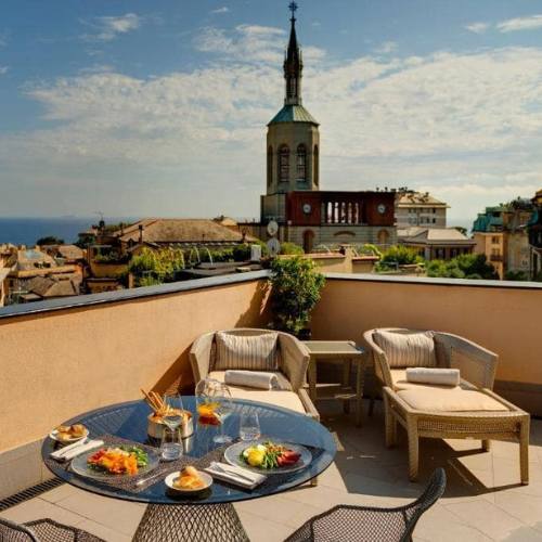 A recommended hotel is pictured for traveling from Nice to Genoa by train.