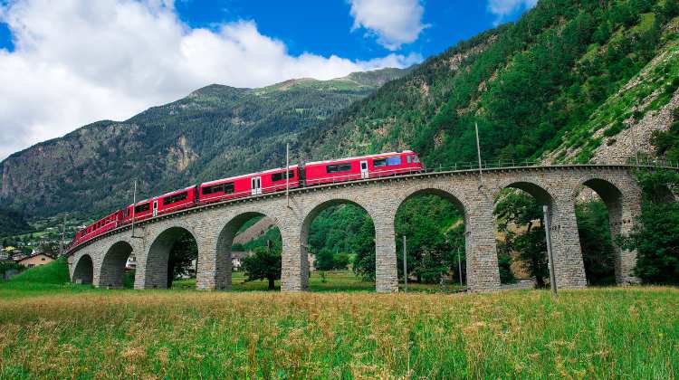 A captivating route from Rome to Paris by train entails taking the Bernina Express train (pictured here) through Switzerland.